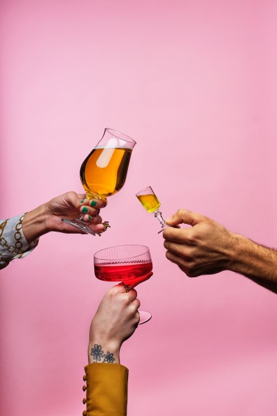 Sicilian Avenue Brand shot two arms interlocked with drinks - High resolution