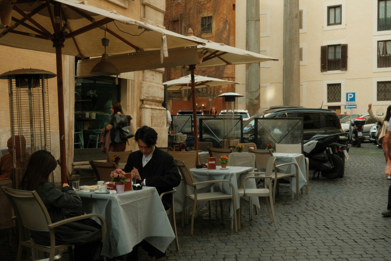 Two Gen-Z people sitting at a street cafe