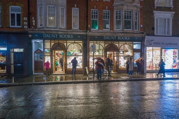 Book store on street with people at night